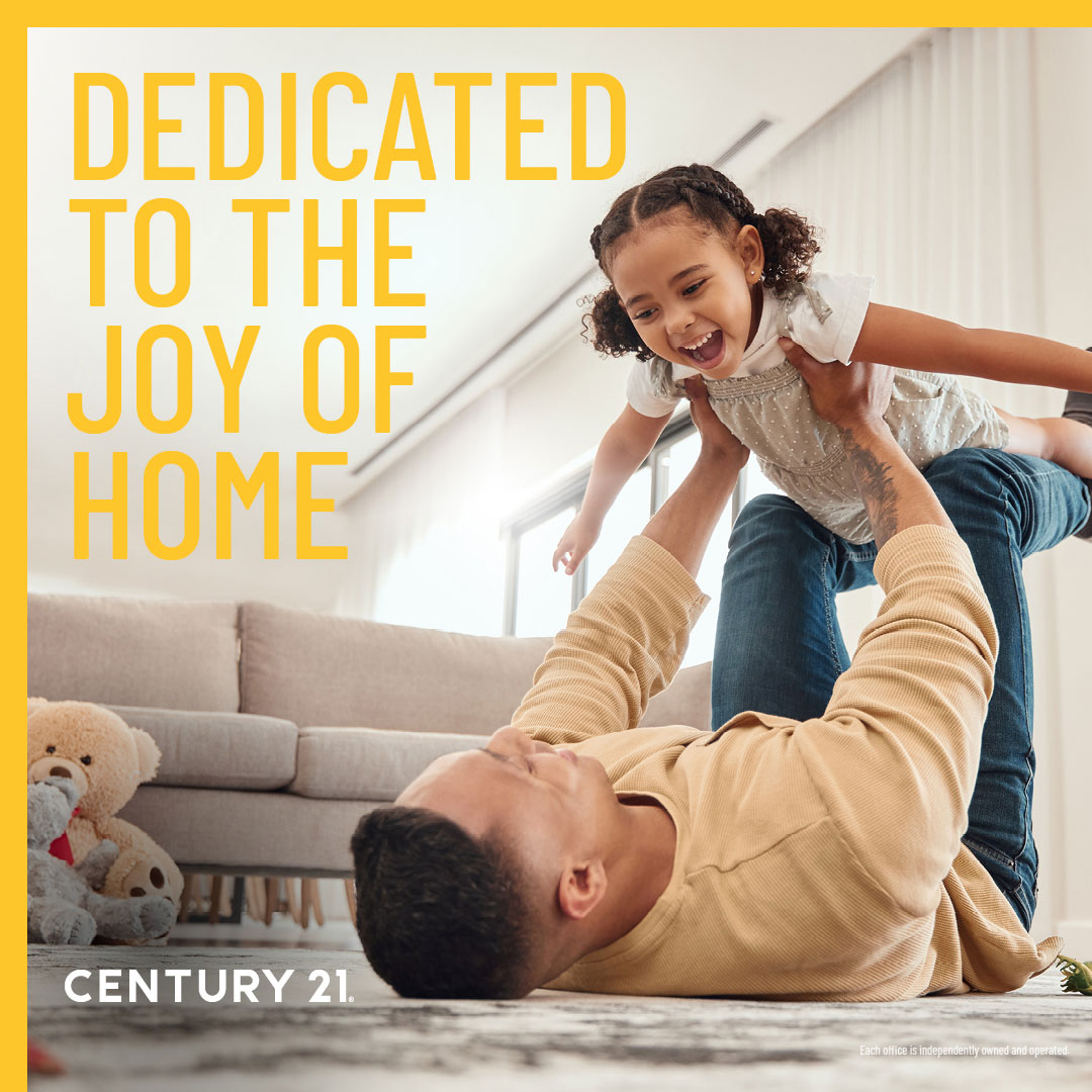dad doing airplane with daughter in century 21 house
